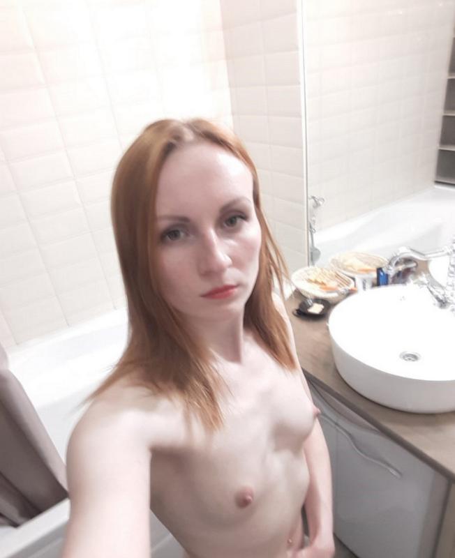 Skinny redhead girl posing in her bathroom naked